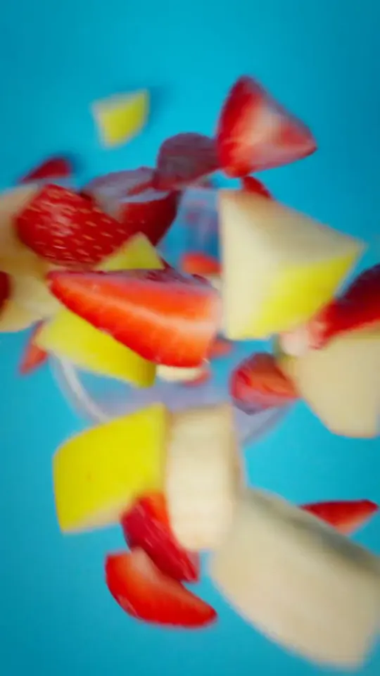 Fruit falling onto the cup, shot from below