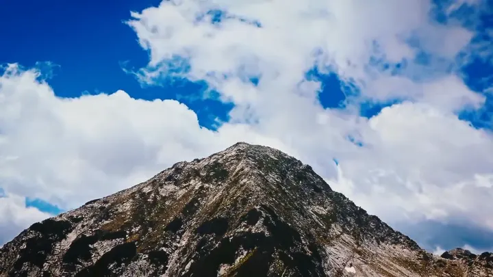 A mountain peak under cloud
